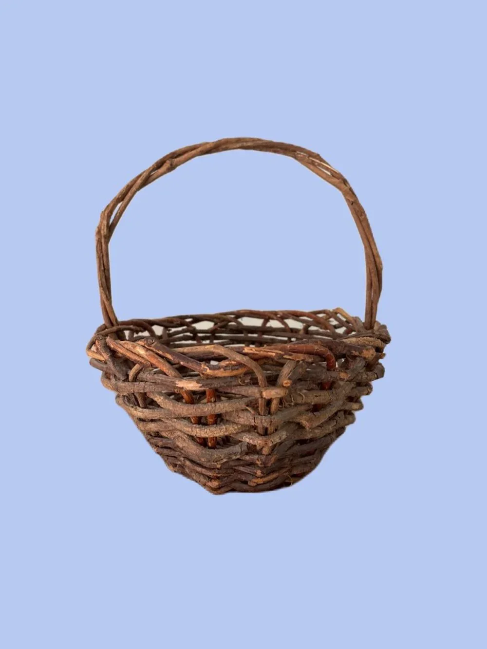 Handwoven vintage twig gathering basket with handle.